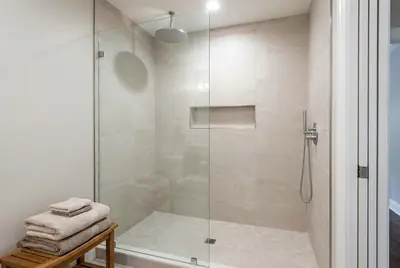 The finished shower standing where the bathtub was